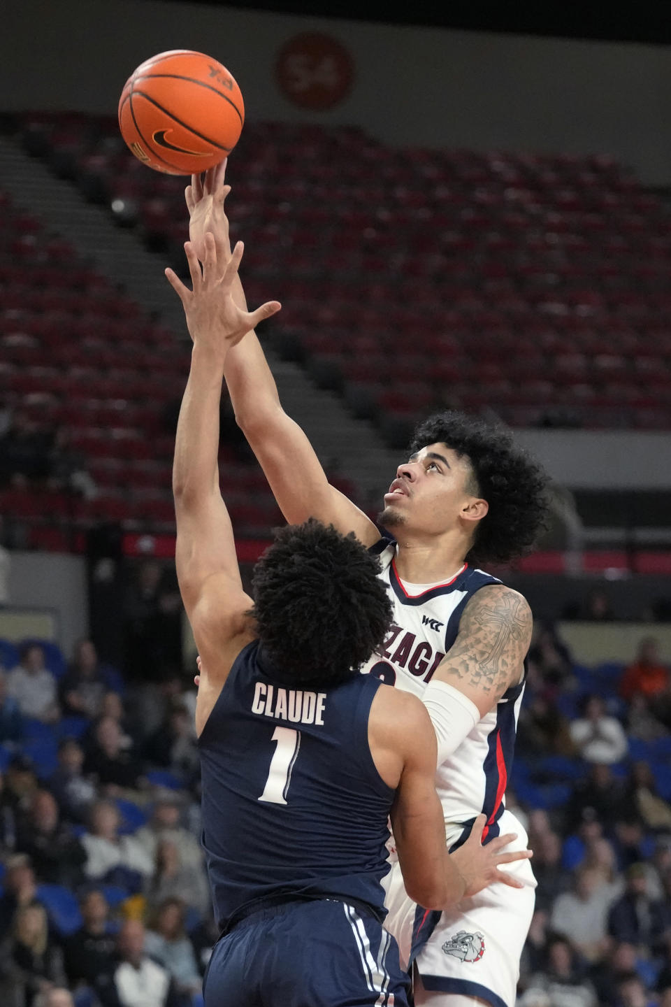 Gonzaga guard Julian Strawther, right, goes to the basket as Xavier guard Desmond Claude (1) defends during the first half of an NCAA college basketball game in the Phil Knight Legacy tournament Sunday, Nov. 27, 2022, in Portland, Ore. (AP Photo/Rick Bowmer)