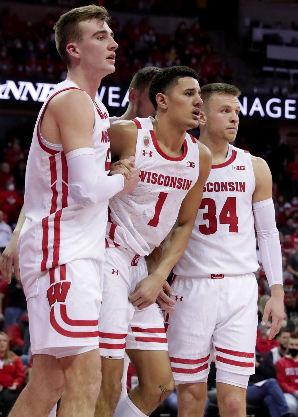 Wisconsin guard Johnny Davis (1) is helped to the sideline after being injured on a flagrant foul during the second half Sunday.