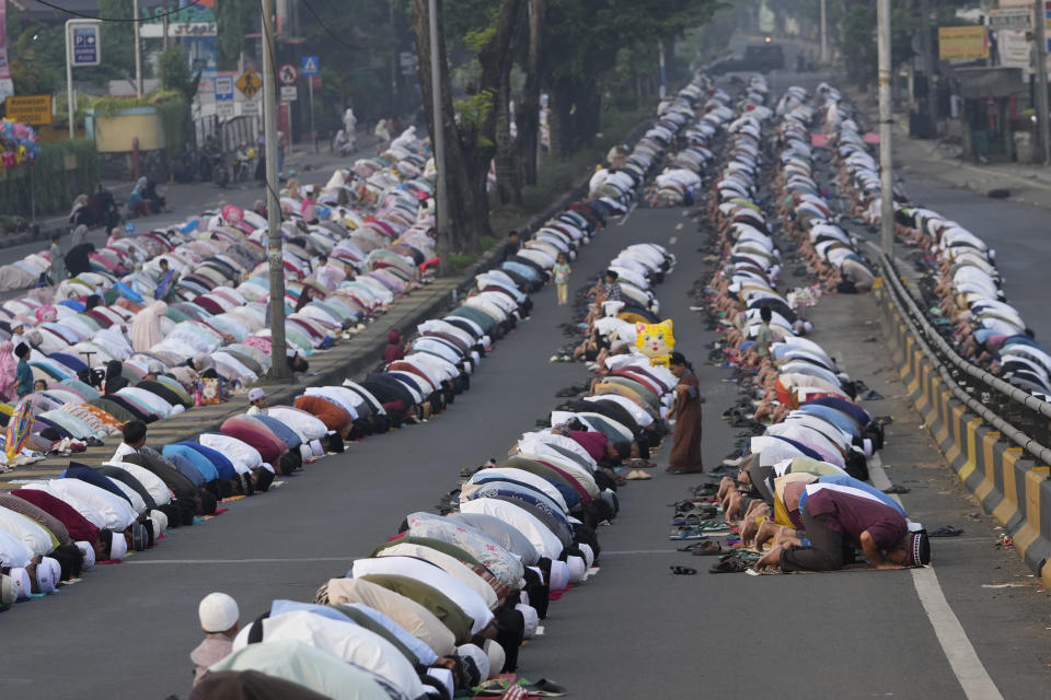 Muslims perform Eid al-Adha prayer on a street in Jakarta, Indonesia, Monday, June 17, 2024. Muslims around the world celebrate Eid al-Adha by sacrificing animals to commemorate the prophet Ibrahim's faith in being willing to sacrifice his son. (AP Photo/Achmad Ibrahim)