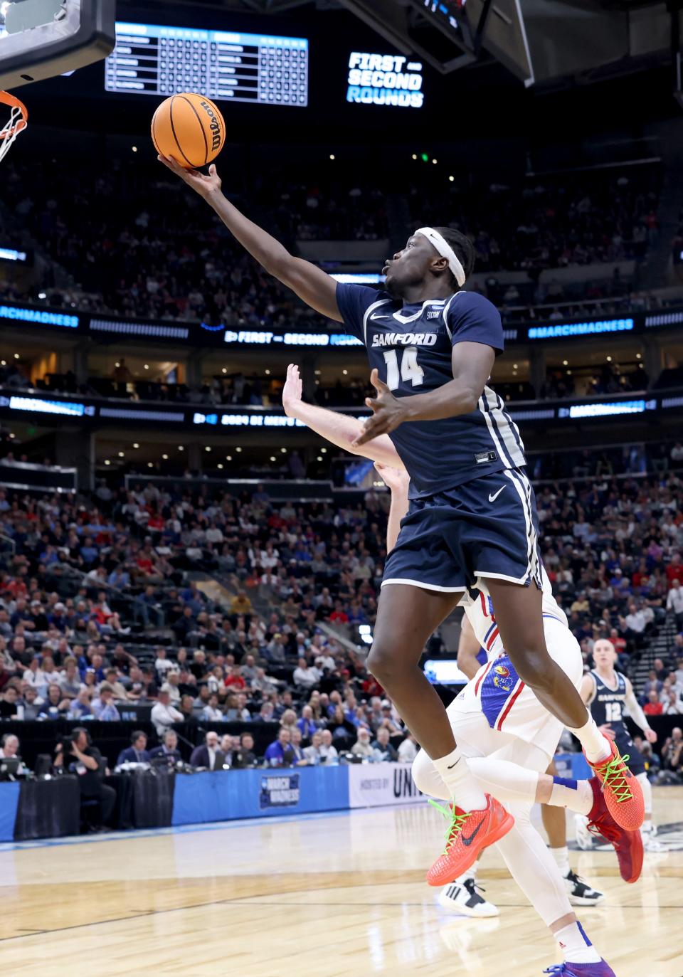 Former Samford offensive lineman Achor Achor (14) shoots during the Bulldogs' NCAA Tournament first-round game against Kansas on March 21 in Salt Lake City, Utah.  Achor has committed to Kansas State for the 2024-25 season.