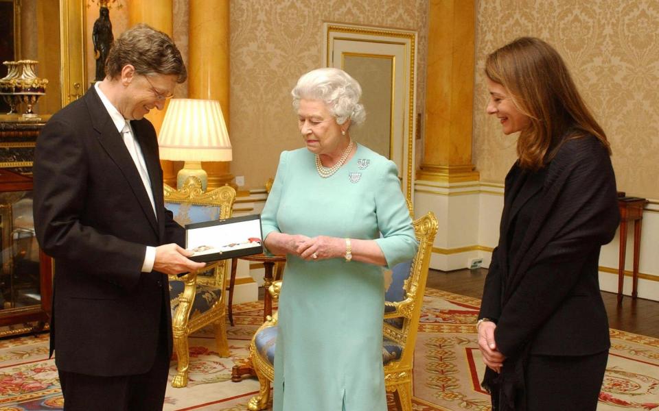 The Queen presents Microsoft tycoon Bill Gates with his honorary knighthood at Buckingham Palace in 2005 - CHRIS YOUNG/AFP via Getty Images