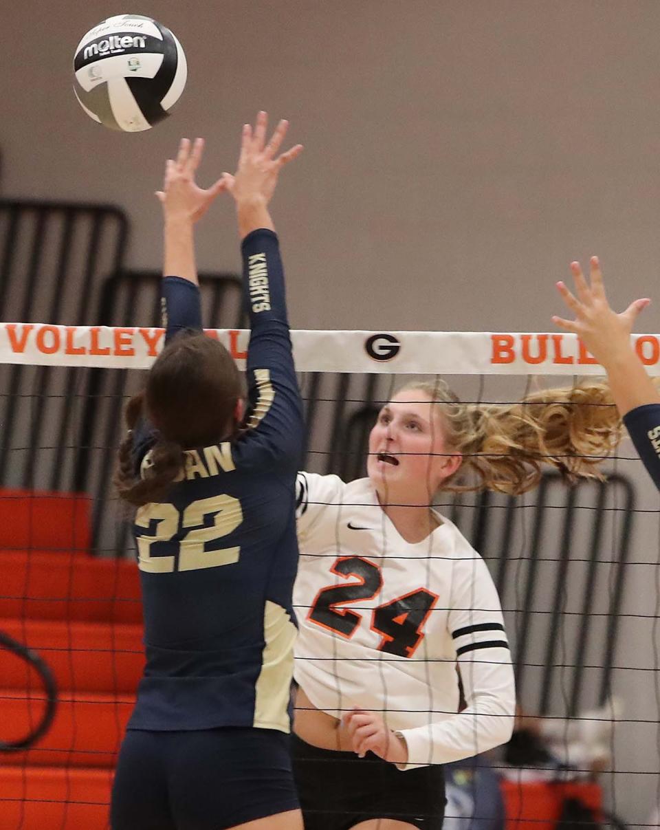 Kassidy Gorsuch, right, of Green hits ball past Anna Rumler of Hoban during the second set of their match at Green High School Wednesday night. Hoban  won 3 sets to 0. 