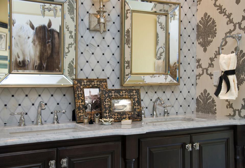 A mix of dark woods, chrome fixtures, and gold and champagne metallic accents add interest and a sense of luxury.