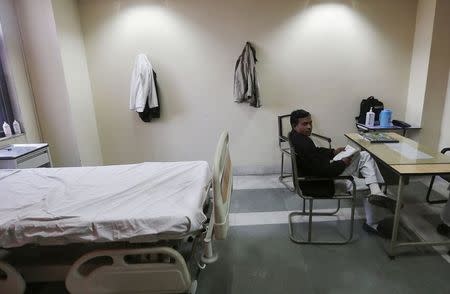 A hospital staff member sits inside a doctor's room at Janakpuri Super Speciality Hospital in New Delhi January 19, 2015. REUTERS/Adnan Abidi