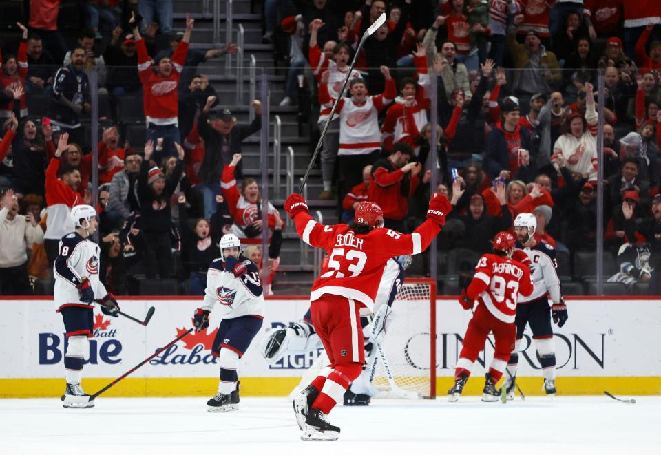 Detroit Red Wings defenseman Moritz Seider (53) celebrates an overtime goal by Patrick Kane against the Columbus Blue Jackets in an NHL hockey game Tuesday, March 19, 2024, in Detroit. (AP Photo/Duane Burleson)