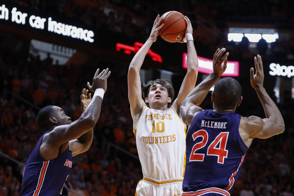 Tennessee forward John Fulkerson (10) shoots over Auburn forward Danjel Purifoy (3) and forward Anfernee McLemore (24) during an NCAA college basketball game Saturday, March 7, 2020, in Knoxville, Tenn. (AP Photo/Wade Payne)