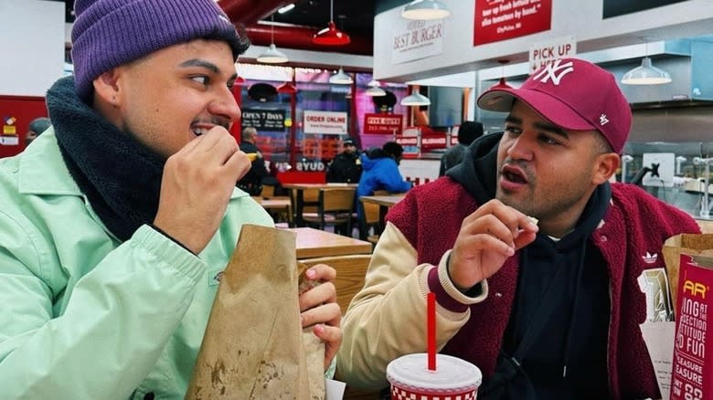 two men eating at Five Guys 