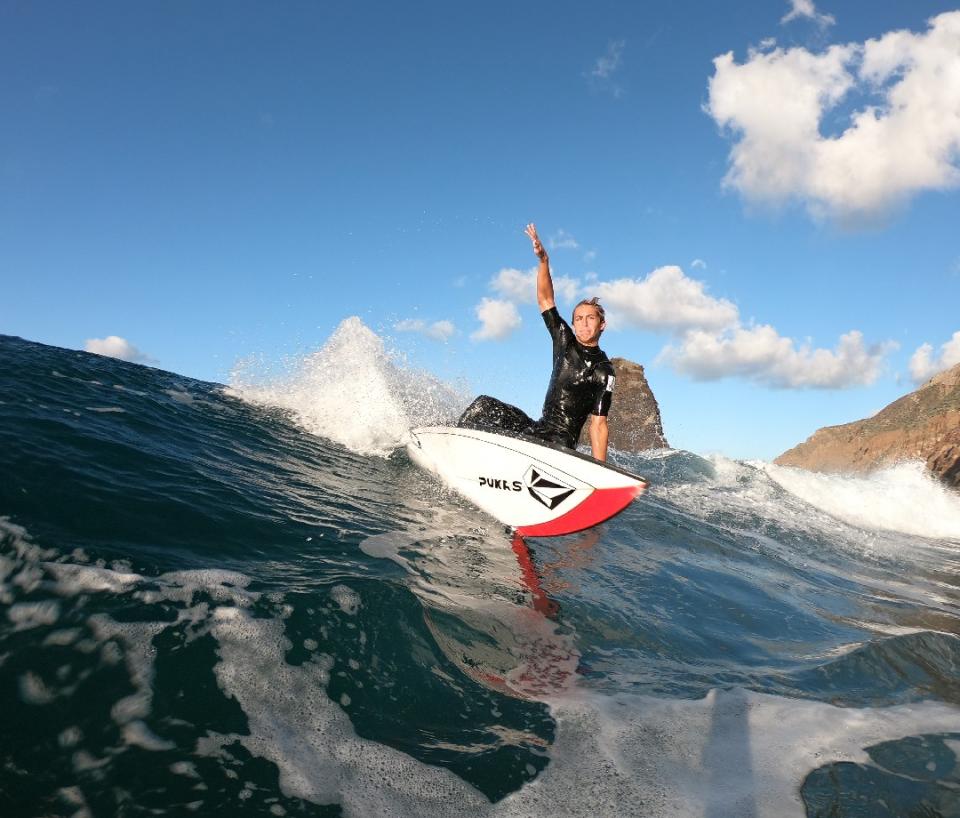 Young male surfer on a wave in Tenerife.