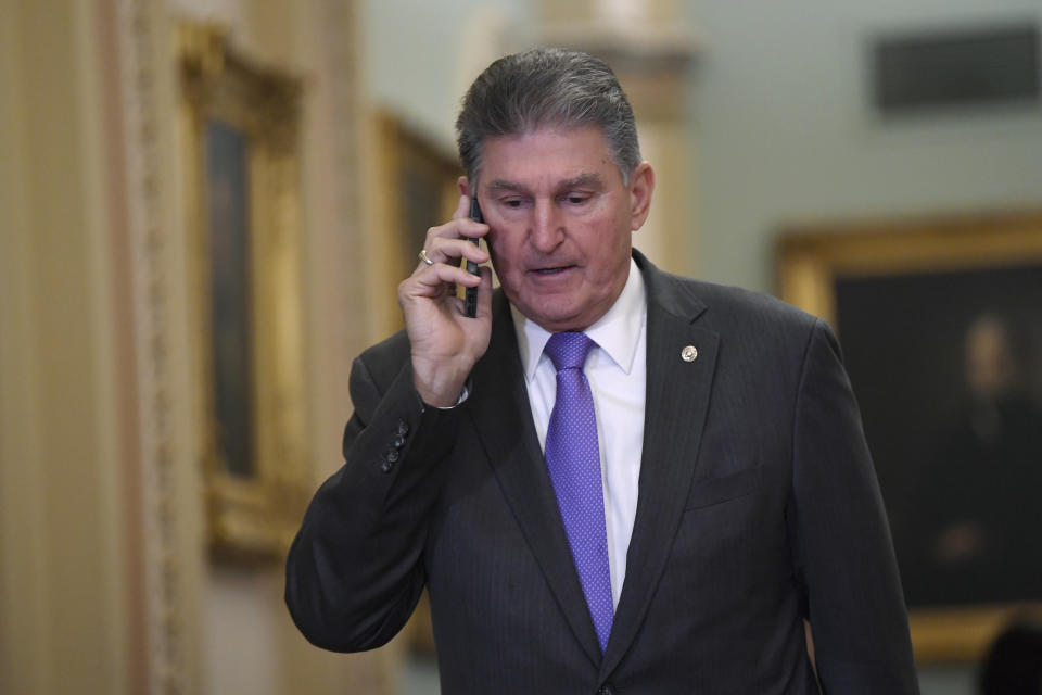 Sen. Joe Manchin, D-W.Va., talks on his phone in Washington, D.C., before the impeachment trial session on Monday, Feb. 3. (Susan Walsh/AP)