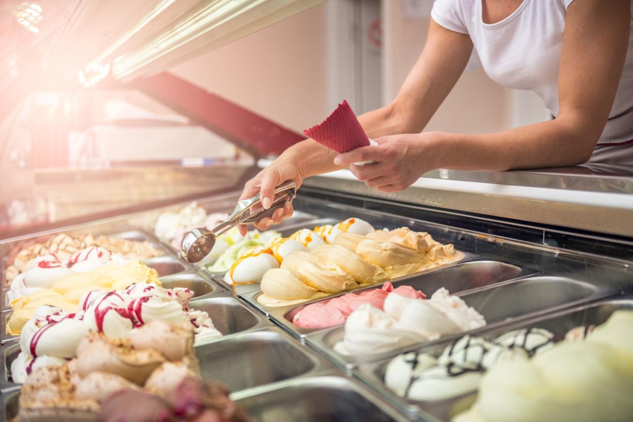 Woman serving ice cream in Confectionery shop