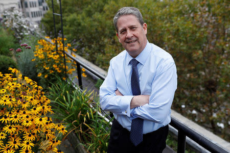 Chief Executive of Coutts private bank, Peter Flavel, poses for a photograph amongst some of the many varieties of plants being grown on the bank's roof in London, Britain October 10, 2017. REUTERS/Peter Nicholls/Files