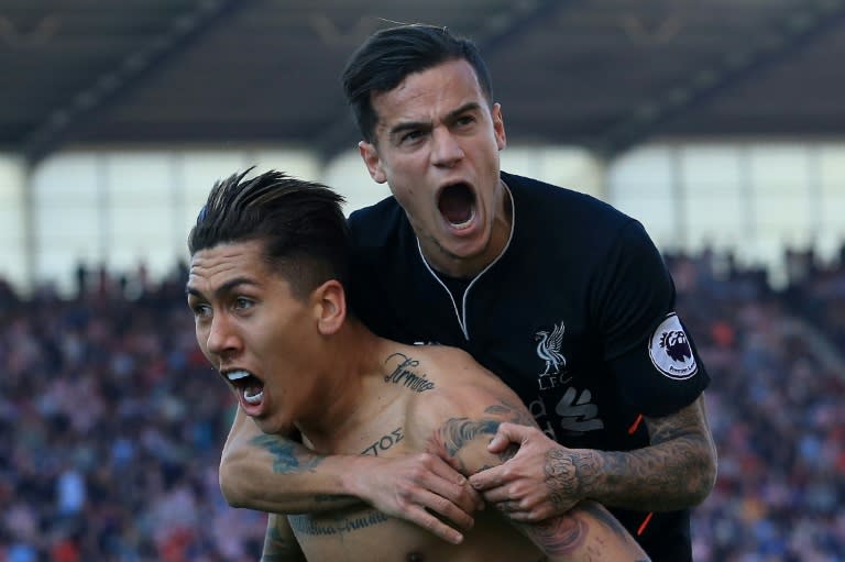 Liverpool's Roberto Firmino (L) celebrates scoring a goal with teammate Philippe Coutinho during their English Premier League match against Stoke City, at the Bet365 Stadium in Stoke-on-Trent, on April 8, 2017