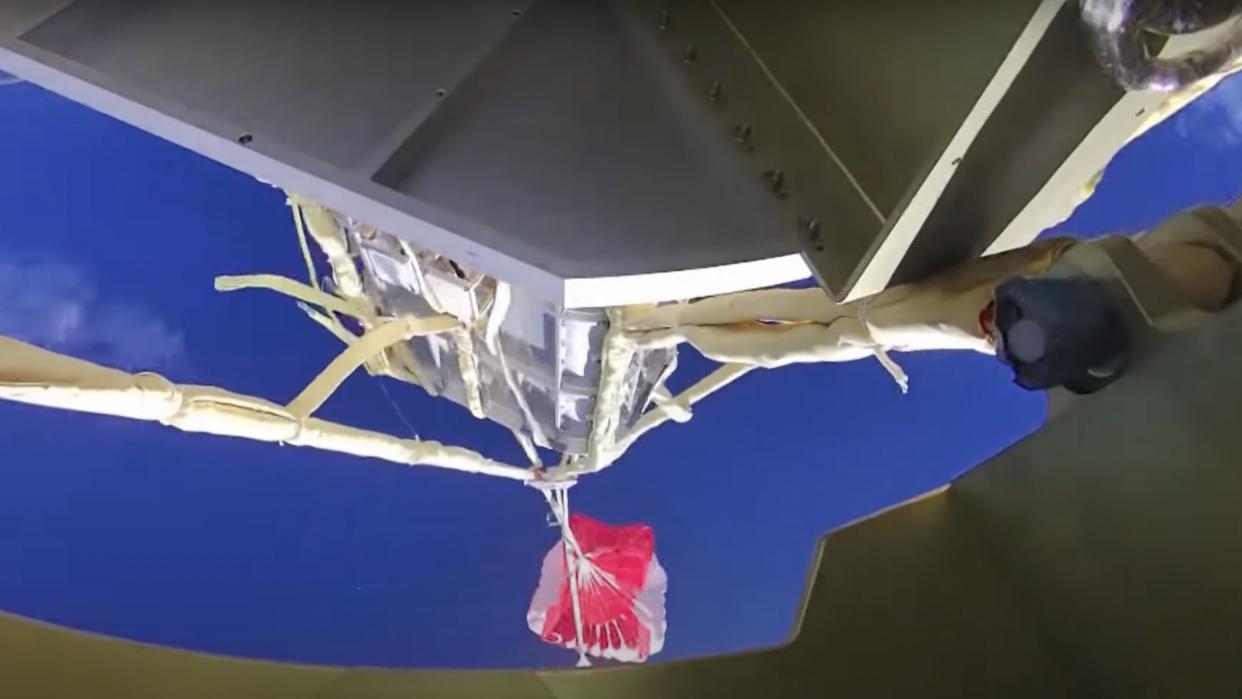  view from a chinese long march 3b rocket looking up at its deployed parachute against a blue sky 