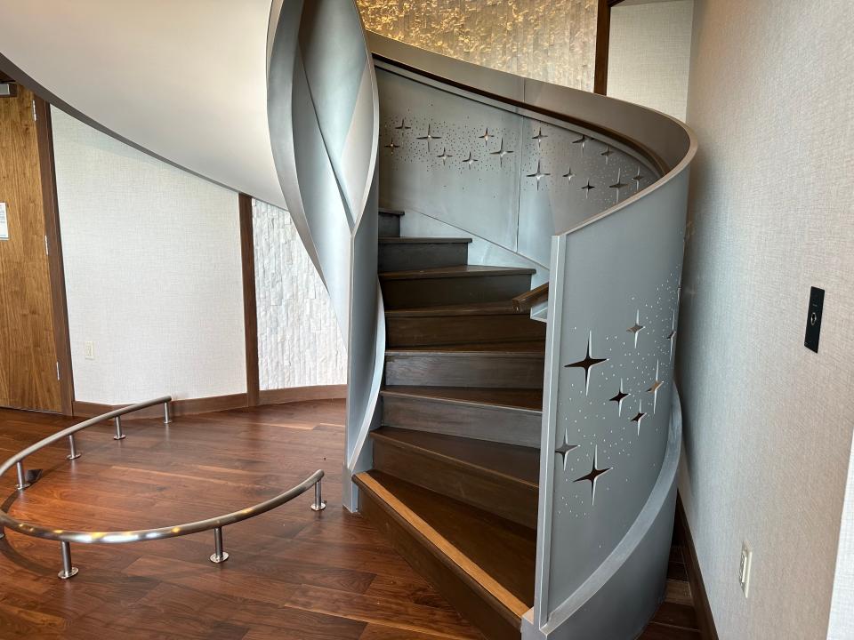 Spiral staircase with sparkle cut-outs and wood steps in grand disneyland villa