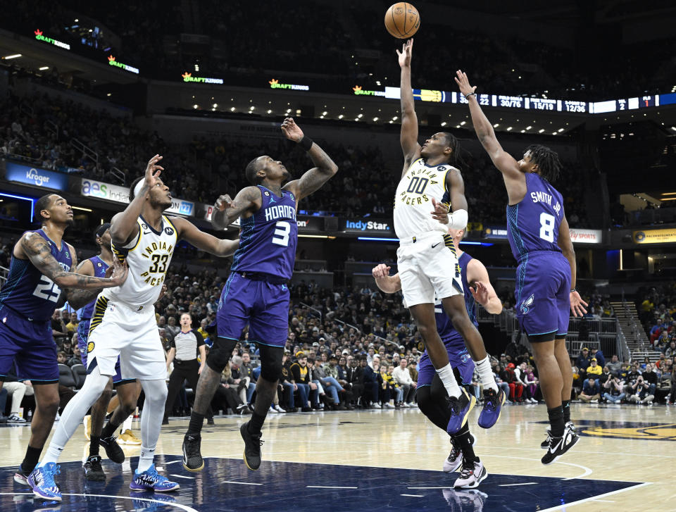 Indiana Pacers guard Bennedict Mathurin (00) shoots during the second half of an NBA basketball game against the Charlotte Hornets, Sunday, Jan. 8, 2023, in Indianapolis. (AP Photo/Marc Lebryk)