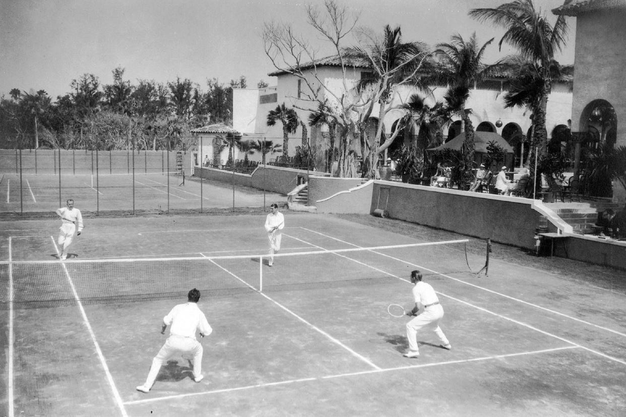 A doubles match at one of the five courts at the Bath & Tennis Club, around 1930.