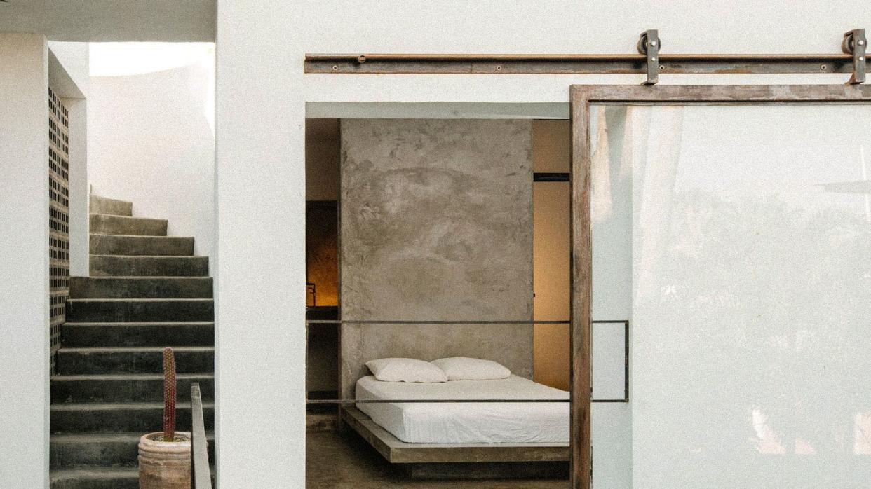 Drift Hotel in San Jose del Cabo's first floor room with minimal design and natural textures like wood, white stucco walls and concrete