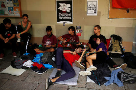 Students rest during a camp out in the University of Barcelona's historic building after thousands of students occupied it during a protest in favor of the October 1st independence referendum in Barcelona, Spain, September 23, 2017. REUTERS/Jon Nazca