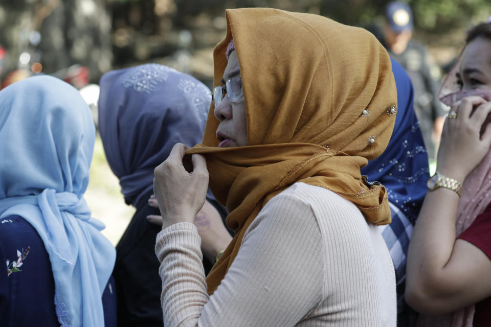 Relatives of the accused wait inside the compound of Camp Bagong Diwa, Taguig city, Philippines, Thursday, Dec. 19, 2019. A Philippine court will rule Thursday whether scions of a political clan and their gunmen are guilty of slaughtering 58 people, including 32 media workers, in an act of impunity that horrified the world. (AP Photo/Aaron Favila)