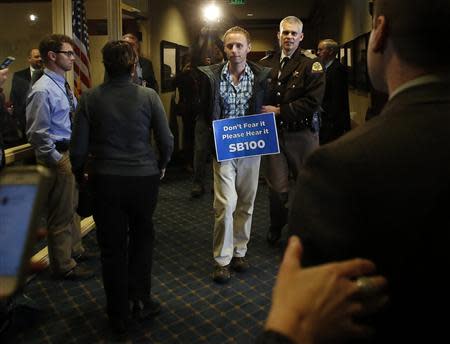 LGBT rights activist are detained by members of the Utah Highway Patrol after blocking a Senate committee hearing room at the Utah State Capitol, February 10, 2014, in Salt Lake City, Utah. REUTERS/Jim Urquhart