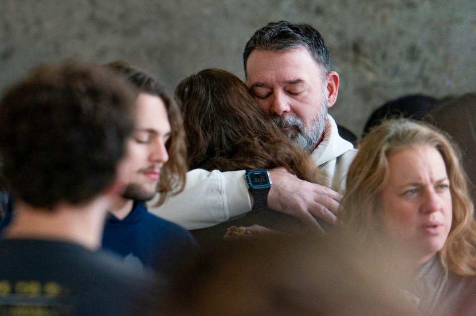 Buck Myre, father of Tate Myre who was killed in the Oxford High School shooting, hugs people in the hallway during a break from the courtroom of Judge Kwame Rowe as Ethan Crumbley, the shooter was sentenced to life without the possibility of parole at the Oakland County Courthouse Friday, Dec. 08, 2023.