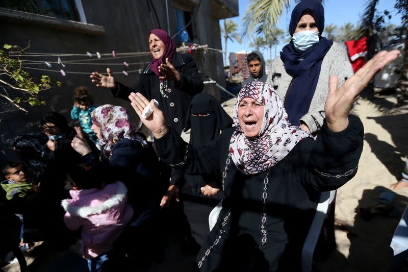 Relatives of three Palestinian fishermen from Allaham family mourn during their funeral in Khan Younis in the southern Gaza Strip