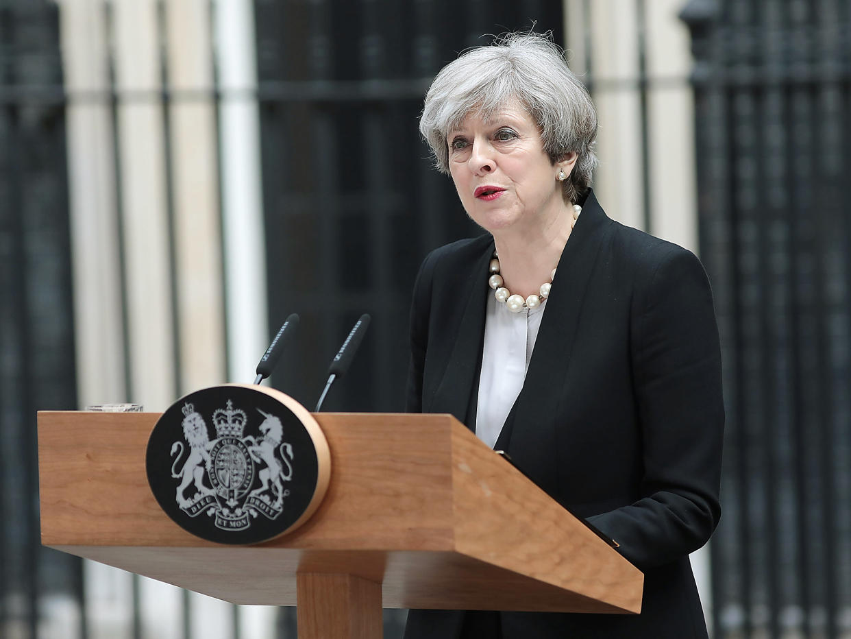 Theresa May addressed the TV cameras outside 10 Downing Street before driving to Manchester to meet injured children: Getty