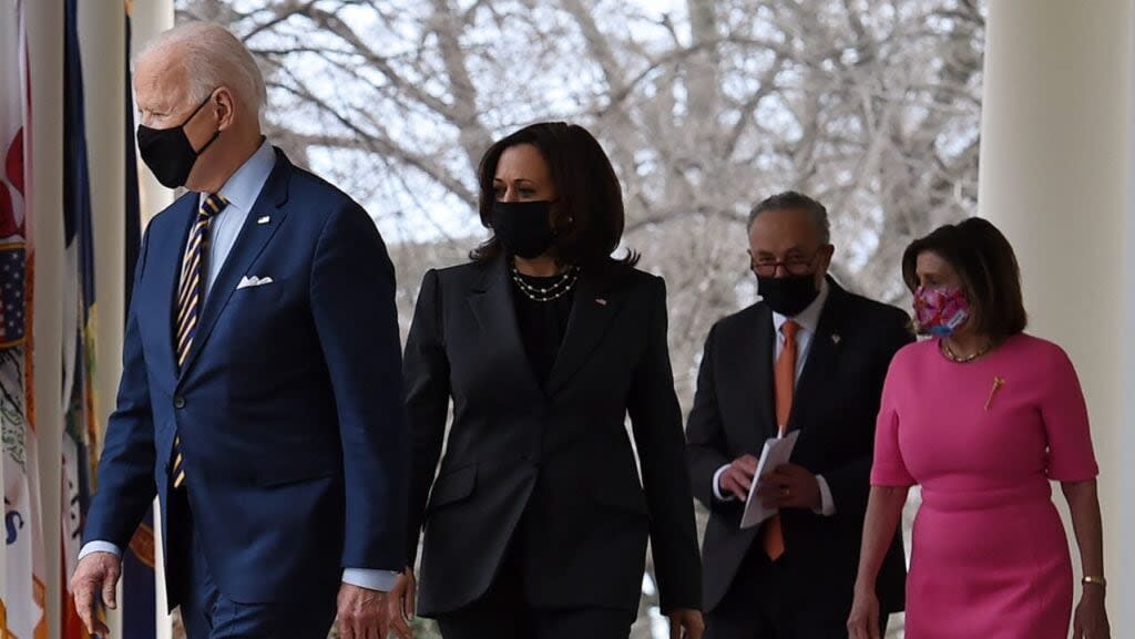 US President Joe Biden, with (L-R) Vice President Kamala Harris, Senate Majority Leader Chuck Schumer, Democrat of New York, and House Speaker Nancy Pelosi, Democrat of California, arrives to speak about the American Rescue Plan in the Rose Garden of the White House in Washington, DC, on March 12, 2021. (Photo by Olivier DOULIERY / AFP) (Photo by OLIVIER DOULIERY/AFP via Getty Images)