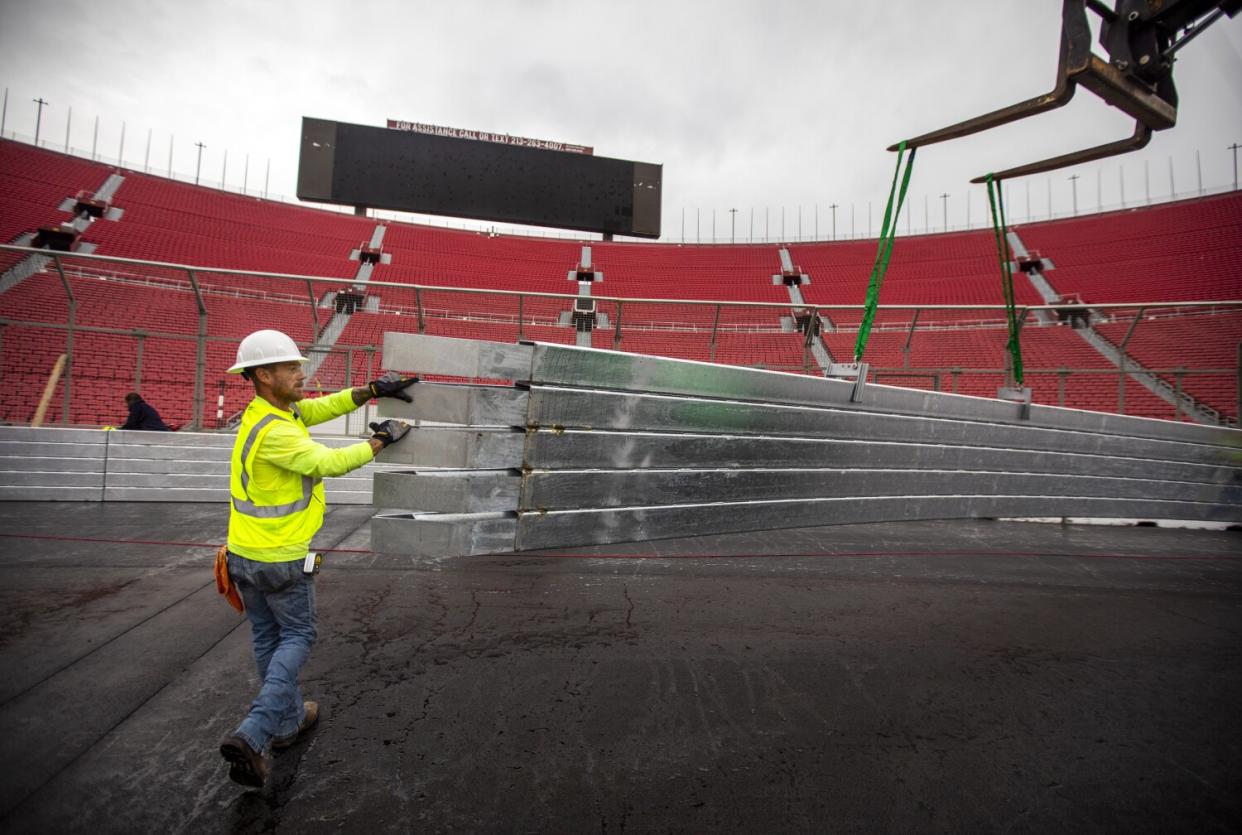 Earl Creach installs a section of the SAFER barrier around the race track at the Coliseum.