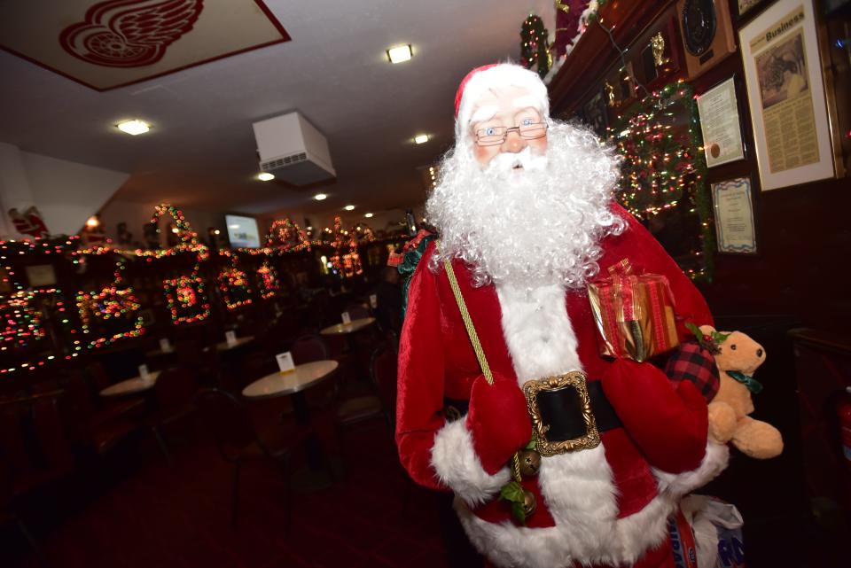 A life-size mannequin of Santa Clause stands by the back-door exit inside the Brass Rail Bar located on Huron Avenue in downtown Port Huron, on Wednesday, Dec. 7, 2022. The bar opened its doors for service for the first time after more than two-and-a-half years.