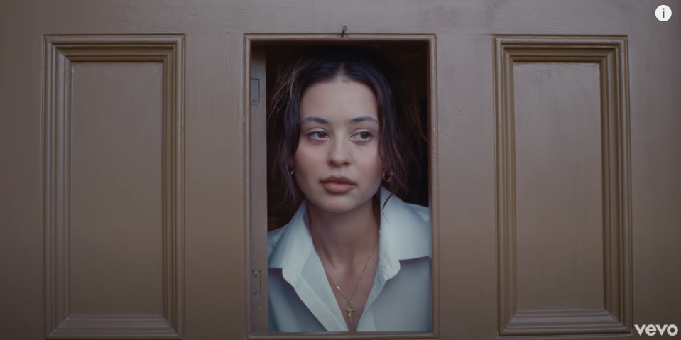 Alexa looking out of a small hole in a door