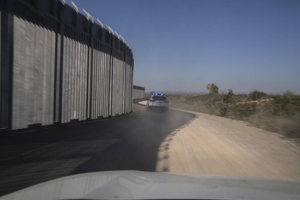 Police border vehicle drives during a patrol along a border wall near the town of Feres, along the Evros River which forms the the frontier between Greece and Turkey on Sunday, Oct. 30, 2022. Greece is planning a major extension of a steel wall along its border with Turkey in 2023, a move that is being applauded by residents in the border area as well as voters more broadly. (AP Photo/Petros Giannakouris)