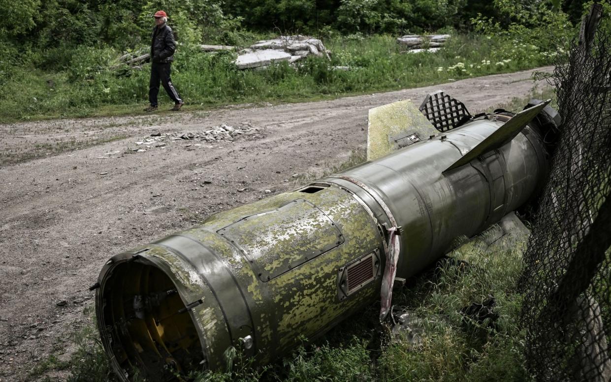 TOPSHOT - A man walks near the remains of a missile in the city of Lysychansk, in the eastern Ukrainian region of Donbas, on May 26, 2022. - Ukraine said may 26 the war in the east of the country had hit its fiercest level yet as it urged Western allies to match words with support against invading Russian forces. Moscow's troops are pushing into the industrial Donbas region after failing to take the capital Kyiv, closing in on several urban centres including the strategically located Severodonetsk and Lysychansk. (Photo by ARIS MESSINIS / AFP) (Photo by ARIS MESSINIS/AFP via Getty Images) - ARIS MESSINIS / AFP