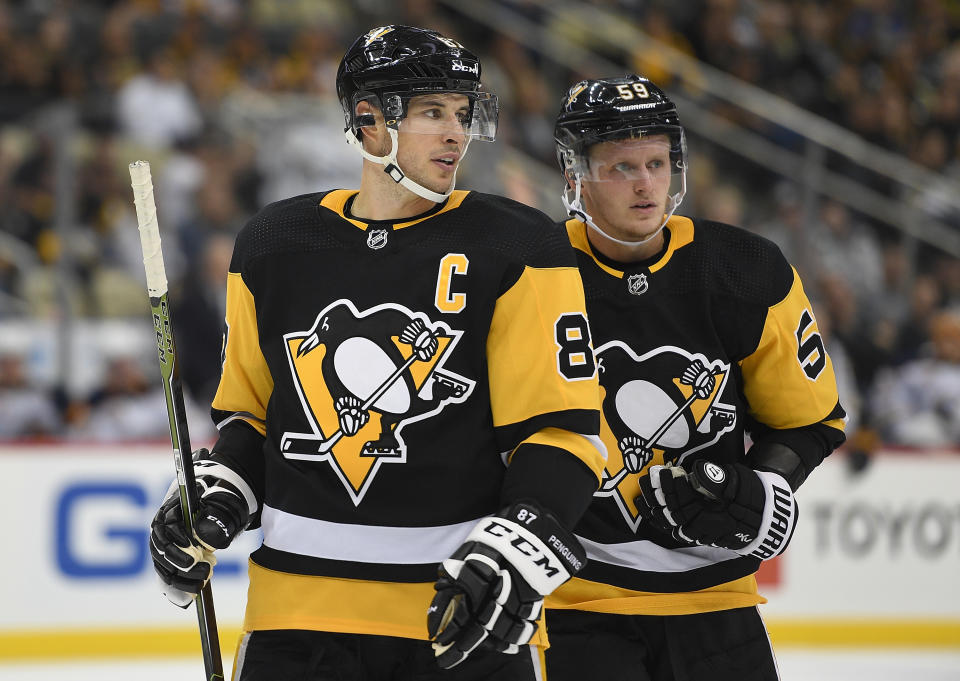 PITTSBURGH, PA - OCTOBER 03: Sidney Crosby #87 of the Pittsburgh Penguins and Jake Guentzel #59 skate towards the faceoff circle in the second period during the game against the Buffalo Sabres at PPG Paints Arena on October 3, 2019 in Pittsburgh, Pennsylvania. (Photo by Justin Berl/Icon Sportswire via Getty Images)