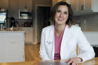 Dr. Michelle Rockwell, who was targeted by vaccine opponents after she posted about her miscarriage online, speaks during an interview at her home Wednesday, April 28, 2021, in Jenks, Okla. Individuals across the country, like Rockwell, have found themselves swept into the misinformation maelstrom, their online posts or their very identities hijacked by anti-vaccine activists and others peddling lies about the COVID-19 outbreak. (AP Photo/Sue Ogrocki)