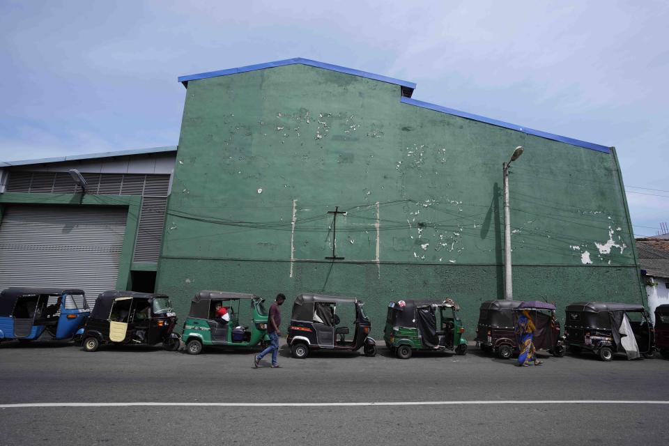 Auto rickshaws queue up outside a fuels station amid fuel shortage in Colombo, Sri Lanka, Tuesday, July 5, 2022. Sri Lanka's ongoing negotiations with the International Monetary Fund have been complex and difficult than the instances before because it has entered talks as a bankrupt nation, the country's prime minister said Tuesday. (AP Photo/Eranga Jayawardena)