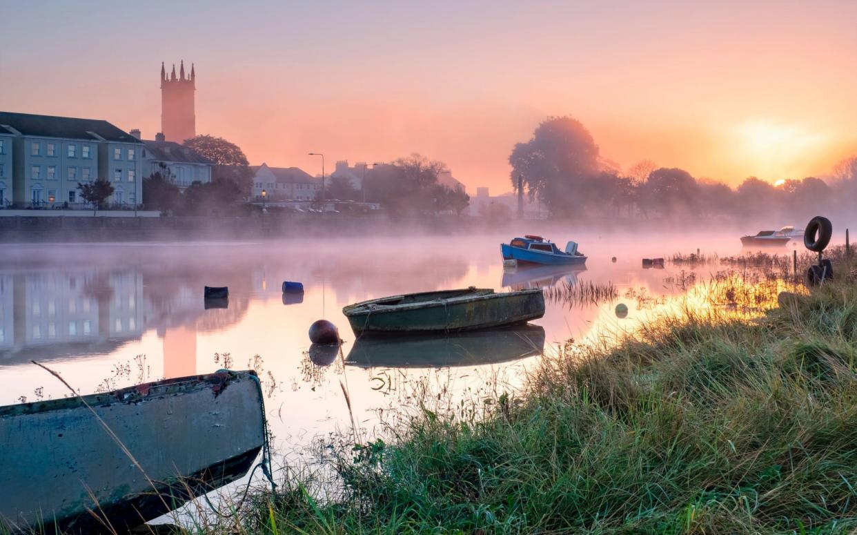 rowing boats on the river bank , North Devon, South West, UK