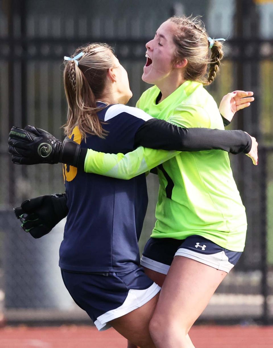 Notre Dame Academy goalie Emelia DaPonte celebrates their Div. 2 state championship win with teammate Lola Griffin in Lynn versus Mansfield on Saturday, Nov. 18, 2023.