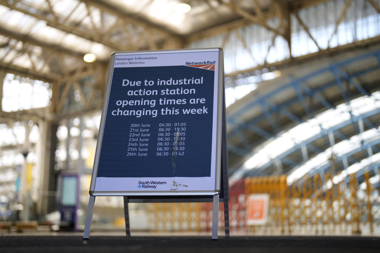 A sign shows the station opening times during this week's industrial action at Waterloo railway station in London, Tuesday, June 21, 2022. Tens of thousands of railway workers walked off the job in Britain on Tuesday, bringing the train network to a crawl in the country’s biggest transit strike for three decades. (AP Photo/Matt Dunham)