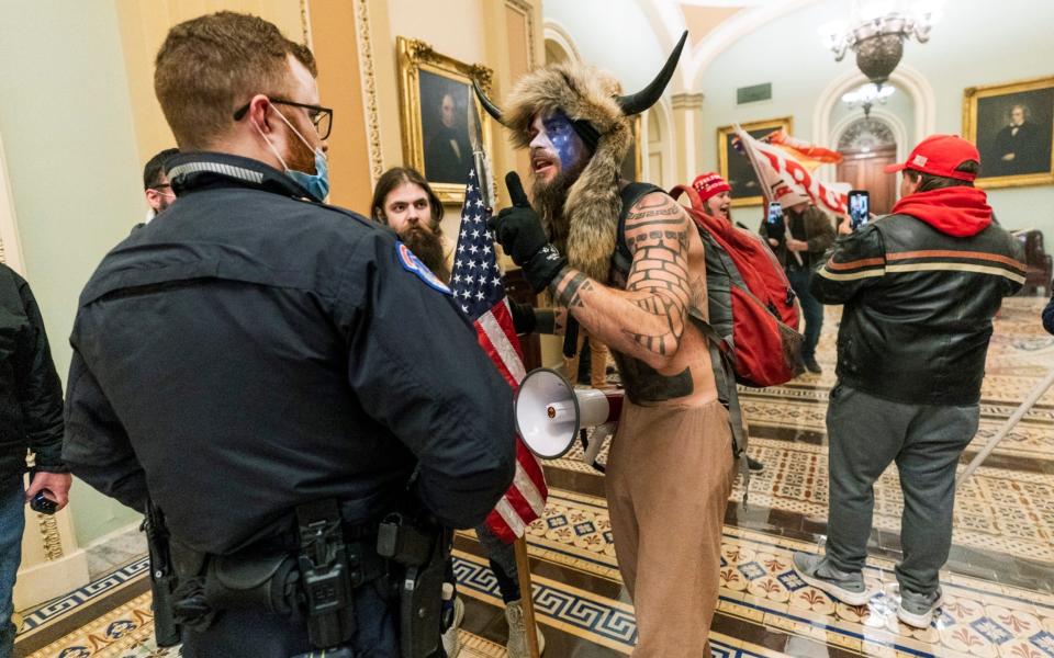 Supporters of President Donald Trump are confronted by U.S. Capitol Police officers outside the Senate Chamber inside the Capitol - AP/Manuel Balce Ceneta