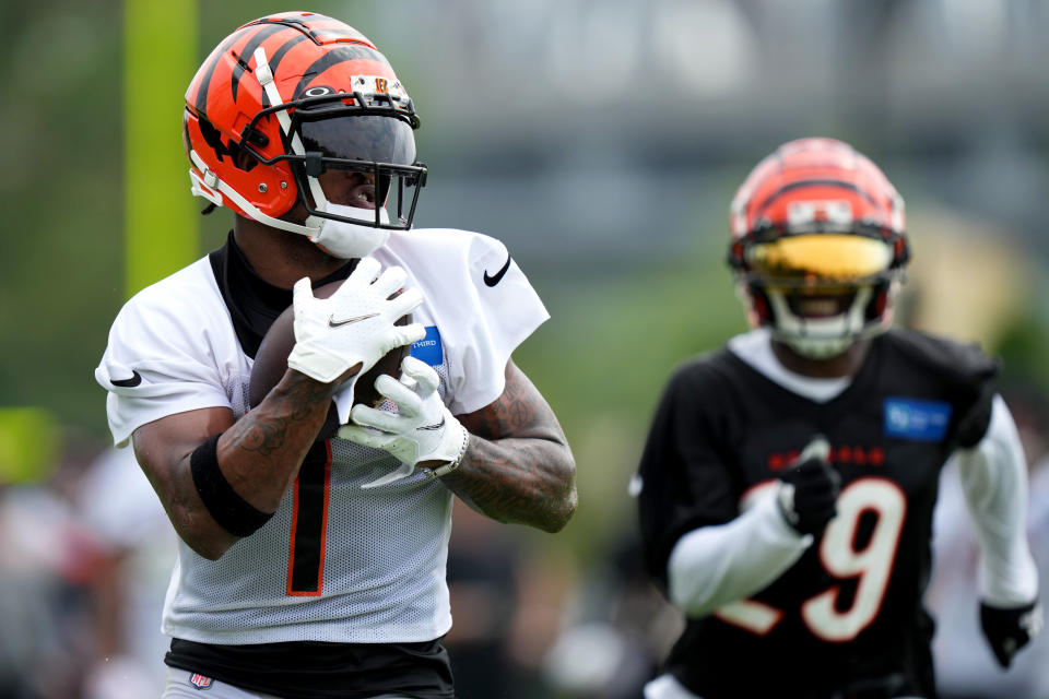 Jul 27, 2023; Cincinnati, Ohio, USA; Cincinnati Bengals wide receiver Ja’Marr Chase (1) competes a catch against cornerback <a class="link " href="https://sports.yahoo.com/nfl/players/34016" data-i13n="sec:content-canvas;subsec:anchor_text;elm:context_link" data-ylk="slk:Cam Taylor-Britt;sec:content-canvas;subsec:anchor_text;elm:context_link;itc:0">Cam Taylor-Britt</a> (29) during training camp practice at the practice fields beside Paycor Stadium. Mandatory Credit: Kareem Elgazzar/The Cincinnati Enquirer-USA TODAY Sports