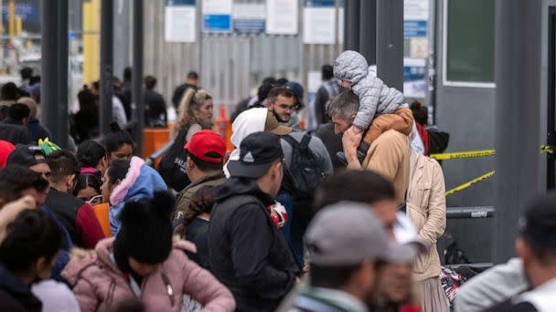 PHOTO: Asylum seekers wait for U.S. Customs and Border Protection agents to allow them enter the country at the San Ysidro crossing port on the US-Mexico border, as seen from Tijuana, Baja California state, Mexico, May 31, 2023. (Guillermo Arias/AFP via Getty Images)