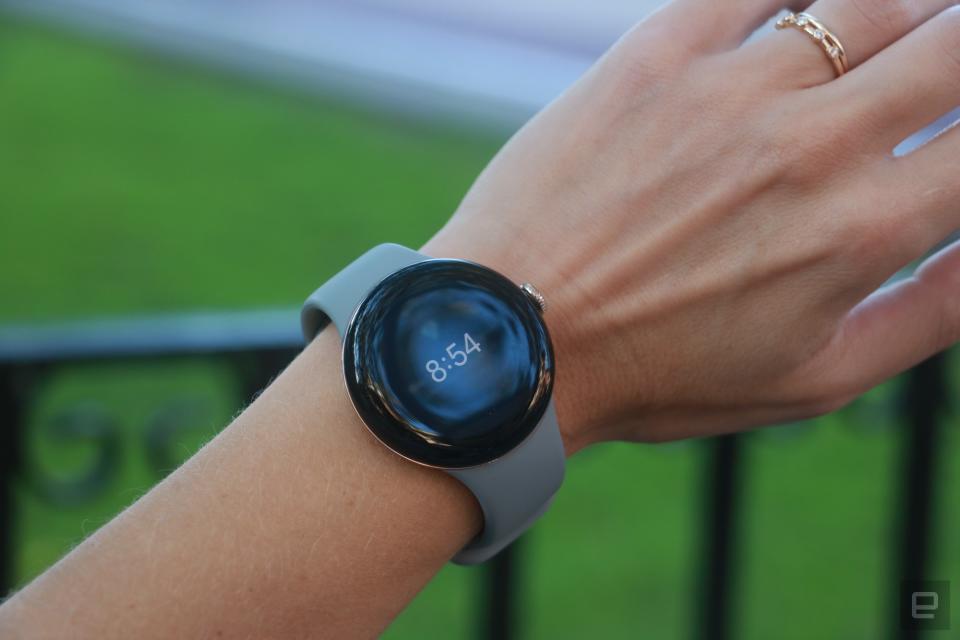 The Pixel Watch 2 on a person's wrist, showing the time overlaid on an exercise summary, as part of the Always On Display feature.