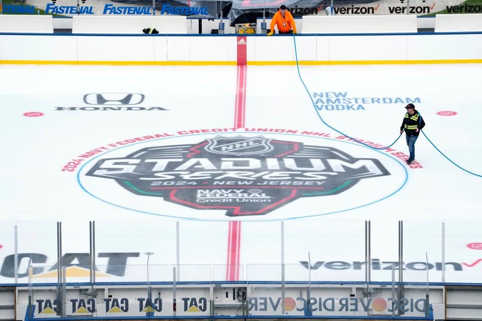 A worker is shown on the ice, Monday, February 12, 2024, where the NHL will host the Stadium Series this weekend.
