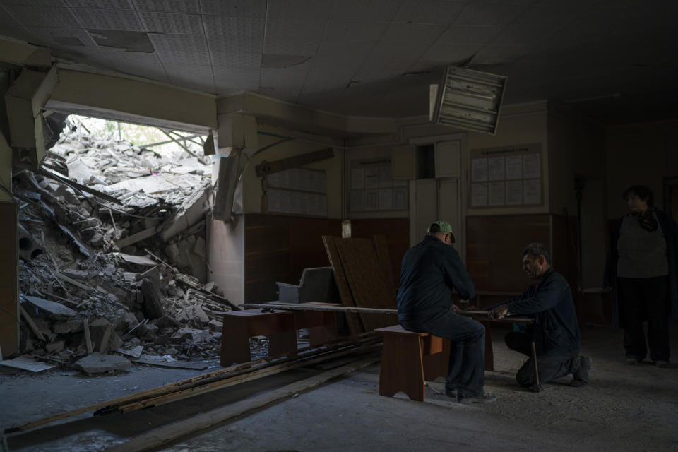 FILE - Men work to close the doors and windows of a psychiatric hospital that was heavily damaged after a Russian attack in Kramatorsk, Ukraine, Sept. 7, 2022. In December, the World Health Organization said one in five people in countries that have experienced conflict in the past decade will suffer from a mental health condition, and estimated that about 9.6 million people in Ukraine could be affected. Russia’s invasion in February 2022 resulted in millions of people being displaced, bereaved, forced into basements for months due to incessant shelling or enduring harrowing journeys from Russian-occupied regions. (AP Photo/Leo Correa, File)
