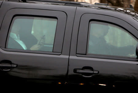 U.S. President Donald Trump looks at a smartphone as he departs the Trump National Golf Club in Potomac Falls, Virginia, U.S., March 26, 2017. REUTERS/Joshua Roberts