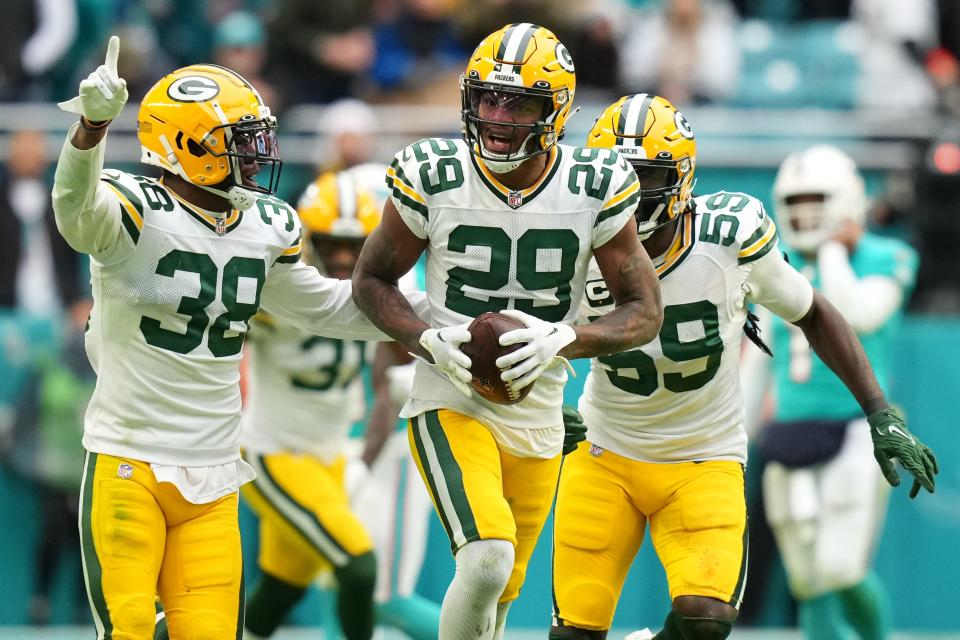 Green Bay Packers cornerback Rasul Douglas (29) celebrates with teammates after intercepting a pass from Miami Dolphins quarterback Tua Tagovailoa late in the fourth quarter.