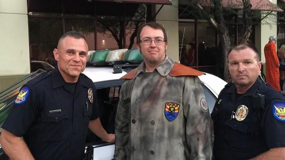 Bryan Patrick Miller, center, who called himself the Zombie Hunter, poses for a photo with police officers. / Credit: Facebook