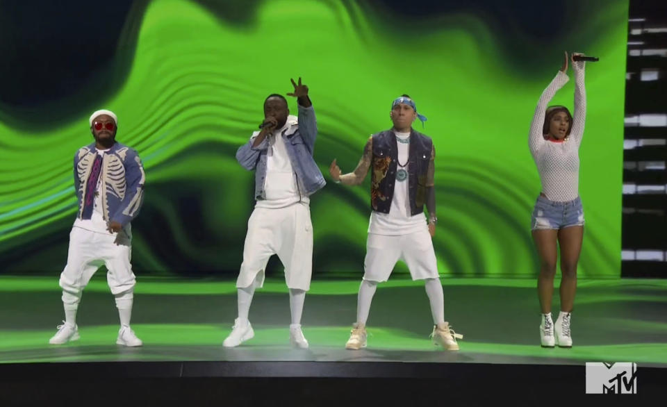 In this video grab issued Sunday, Aug. 30, 2020, by MTV, apl.de.ap, from left, will.i.am, Taboo and J. Rey Soul, of Black Eyed Peas, perform during the MTV Video Music Awards. (MTV via AP)