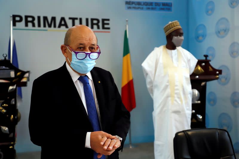 French Foreign Minister Jean Yves Le Drian speaks to journalist as Malian Prime Minister Moctar Ouane listens in Bamako